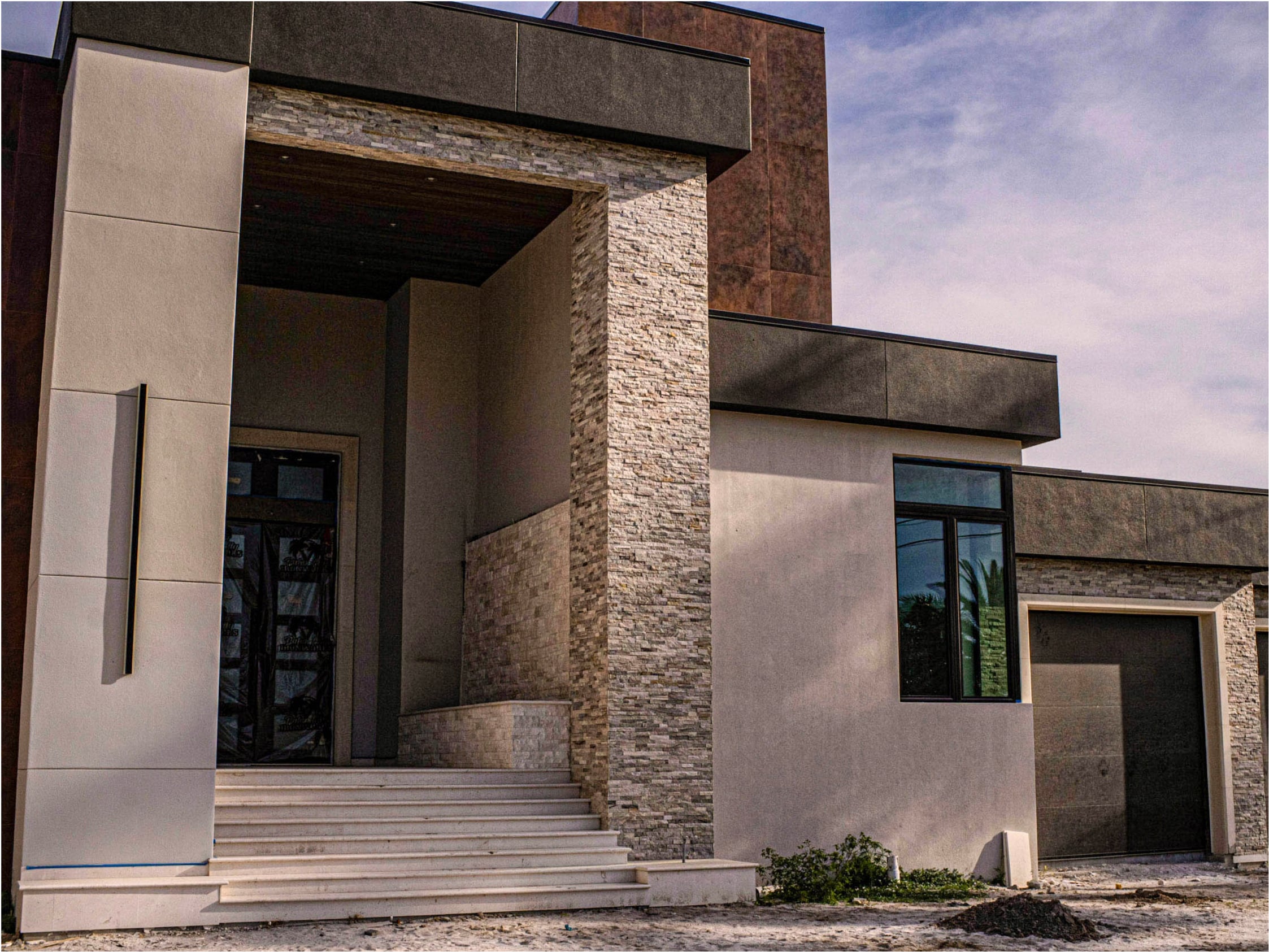 Modern entry portico with cast columns